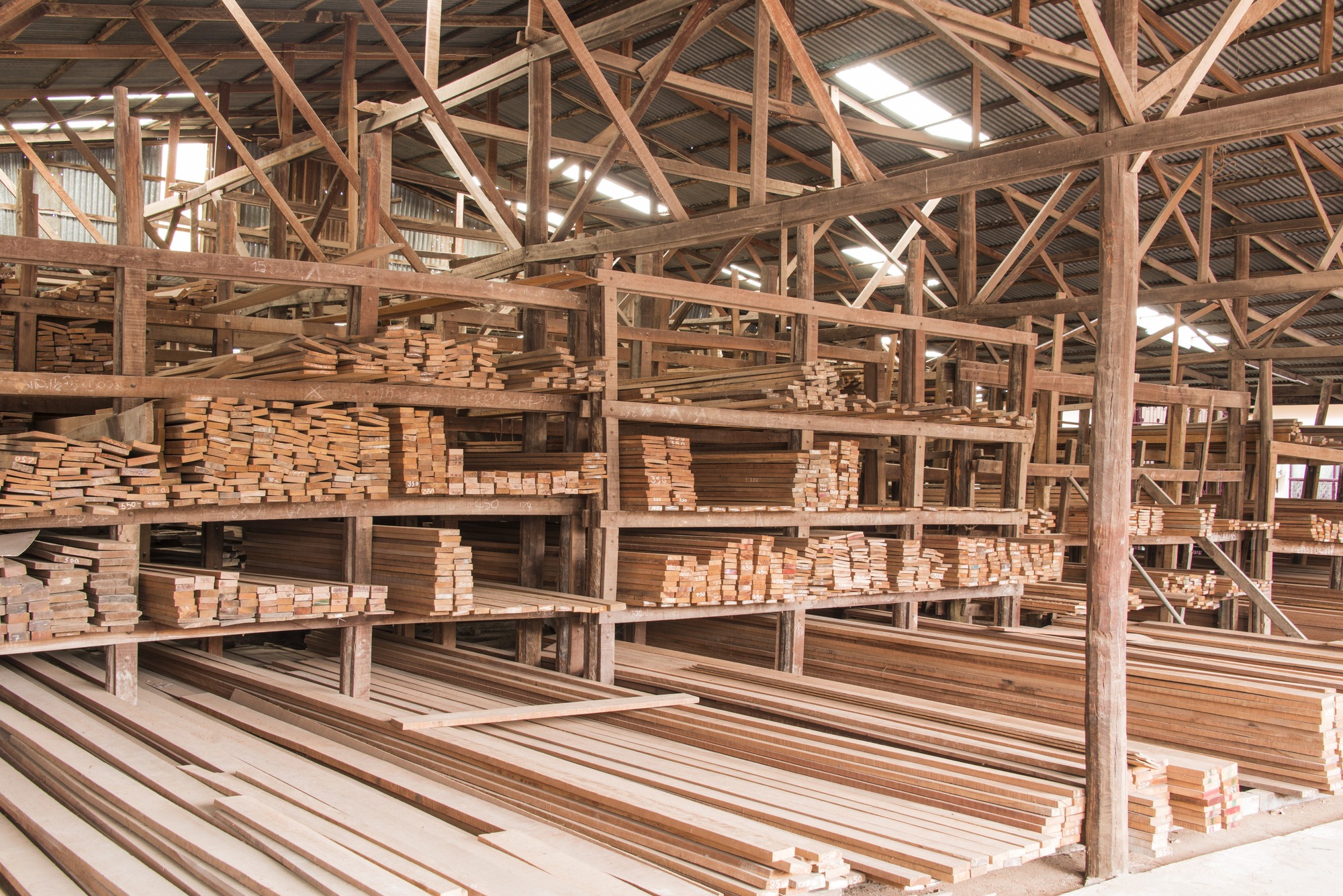 Wood stacked on shelving inside a lumber yard